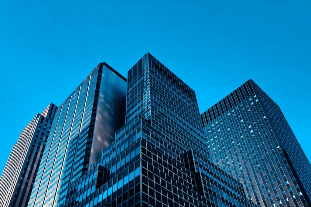 Photo of three buildings with blue sky