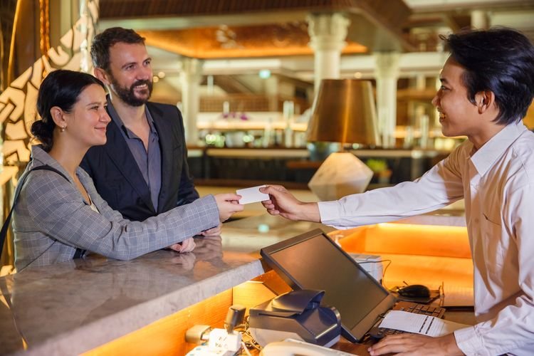 Foreign tourists in Indonesia checking into a hotel, highlighting the country's hospitality and growing appeal to international travelers.