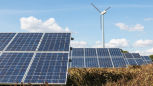 Indonesia's renewable energy project featuring a field with solar panels and a wind turbine, showcasing clean energy sources.