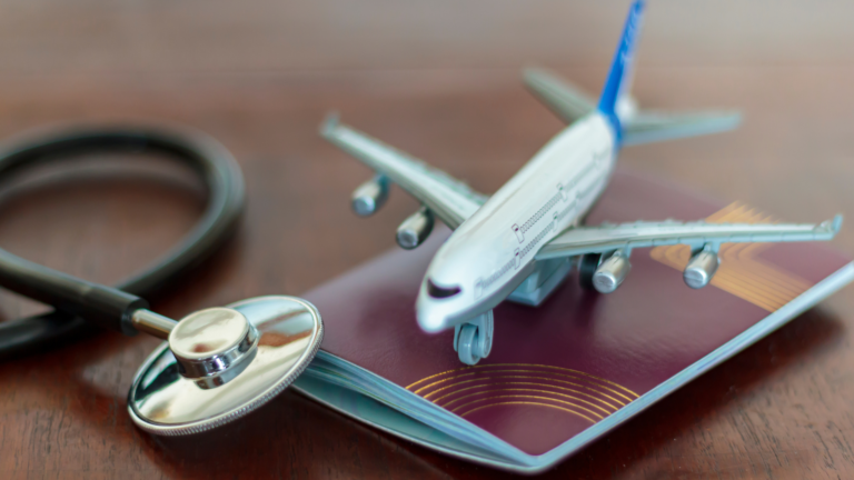 A model airplane sits on a passport next to a stethoscope, signifying global tourism recovery.