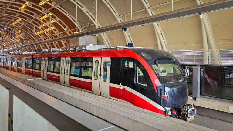 A modern Light Rail Transit (LRT) train in Indonesia, stationed at an elevated platform inside a well-lit terminal signifying the Transportation sector as one of the sectors in Indonesia's foreign investment trends.