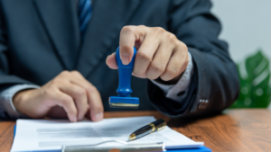 Apostille Document Legalization in Indonesia symbolized by a businessman in a suit stamping a document with a blue seal.