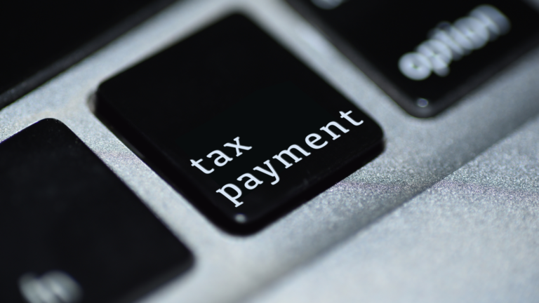 Close-up of a black keyboard key labeled "tax payment," symbolizing the digital tax system, including the Jakarta E-TRAPT Tax System.