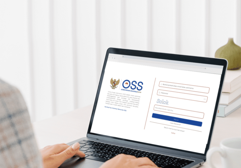 Indonesian business registration process illustrated by a person accessing the OSS (Online Single Submission) website on a laptop.