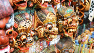 Colorful traditional Balinese masks displayed at a market stall, showcasing the intricate craftsmanship of the Bali handicraft business.