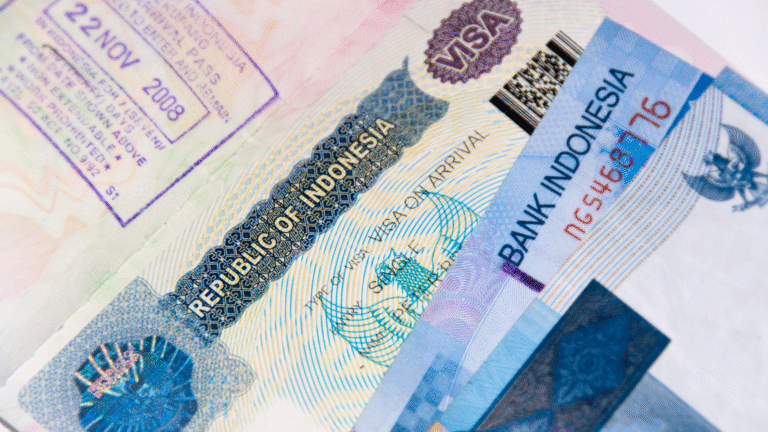 A close-up of a passport with an Indonesian visa on arrival sticker, illustrating the documentation needed to avoid potential Indonesia visa problems for travelers.