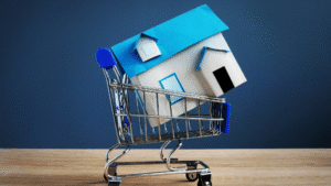 A miniature house sits inside a shopping cart, symbolizing the potential pitfalls and mistakes foreigners make buying property in Indonesia.