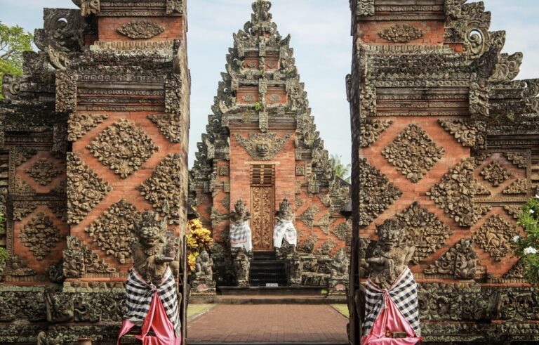 Entrance gate of Pura Puseh Desa Batuan, a traditional Balinese temple in Gianyar, showcasing intricate carvings and cultural heritage often admired by those living in Gianyar as expats.