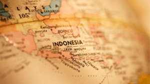 Close-up of a vintage map showing Indonesia’s islands and cities, illustrating why people move to Indonesia for its location.