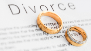 Two wedding rings placed on a divorce document symbolizing legal separation and divorce in Indonesia.