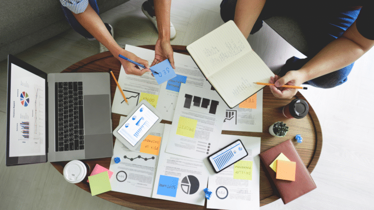 A business team analyzing company structures on a laptop and printed documents, visually highlighting the key differences in PT PMA vs PT for foreign investors.