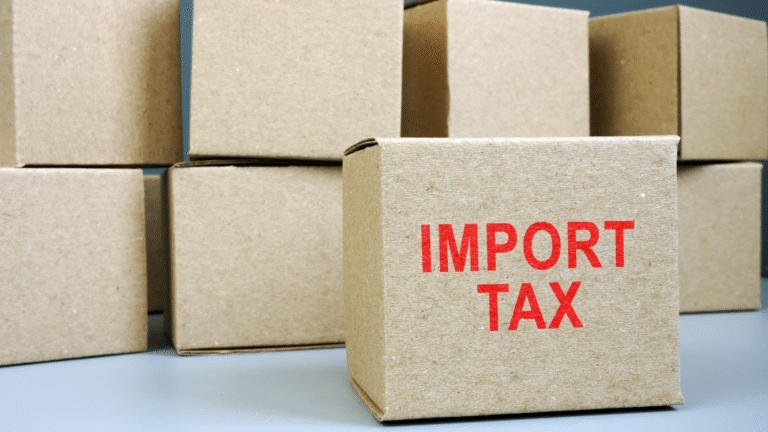 Stacked cardboard shipping boxes with one box labeled “IMPORT TAX,” representing costs and regulations related to Indonesia import tax.