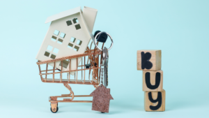 Wooden blocks with the word buy and a miniature house on a shopping cart illustrating the property purchase process in Indonesia